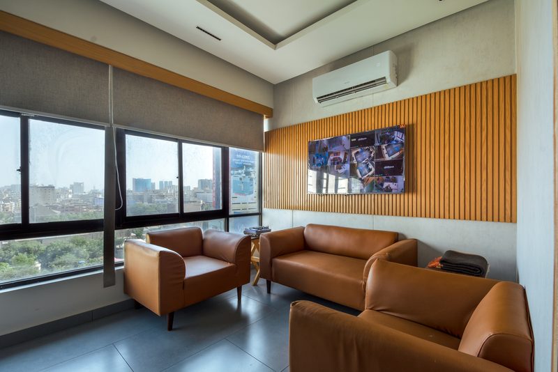 The waiting lounge at Factor Solar, in leather and fluted timber.