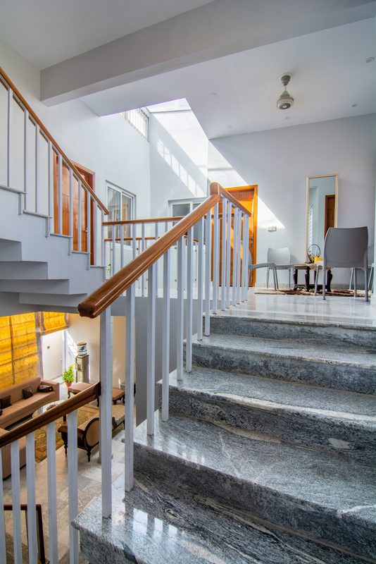 The stair landing at Khurrum Residence, in stone and painted steel.
