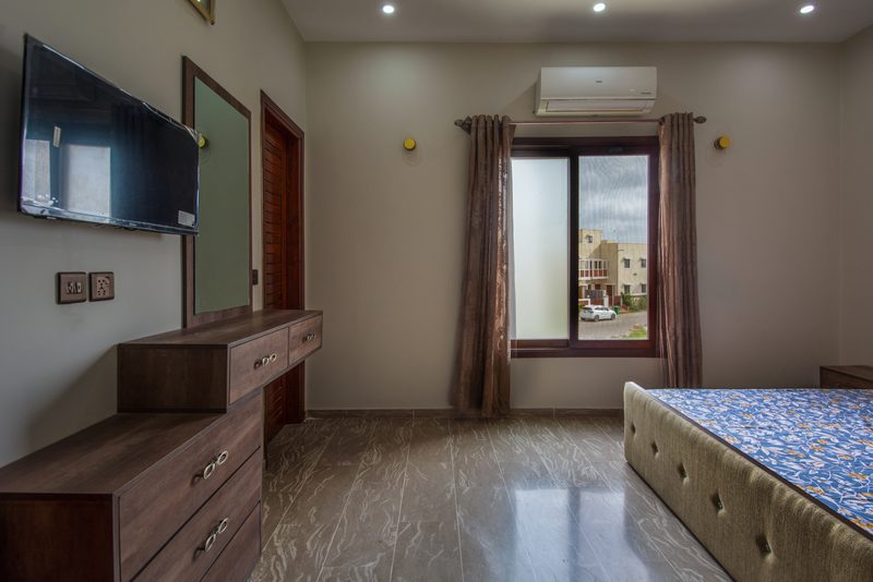 A bedroom at Naeem Residence with fitted joinery by Petra Constructors.